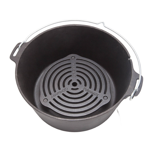 Solid cast iron grate with raised legs positioned inside a Dutch oven, designed for superior heat management during multi-level baking and roasting, ideal for camping and kitchen collections.