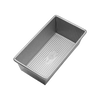 Rectangular non-stick aluminized steel loaf pan with corrugated surface for even baking, handcrafted in the USA, featured in Kitchen & Food, Cookware, Baking Supplies, and Bread Making Supplies collections.