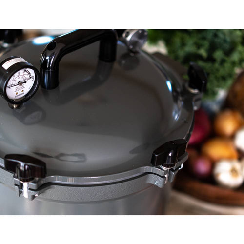 Gray pressure canner with secure locking lid, built-in pressure gauge, and sturdy handle, designed for safe food preservation in Kitchen & Food, Canning, and USA Made collections.