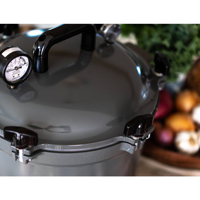 Gray pressure canner with secure locking lid, built-in pressure gauge, and sturdy handle, designed for safe food preservation in Kitchen & Food, Canning, and USA Made collections.