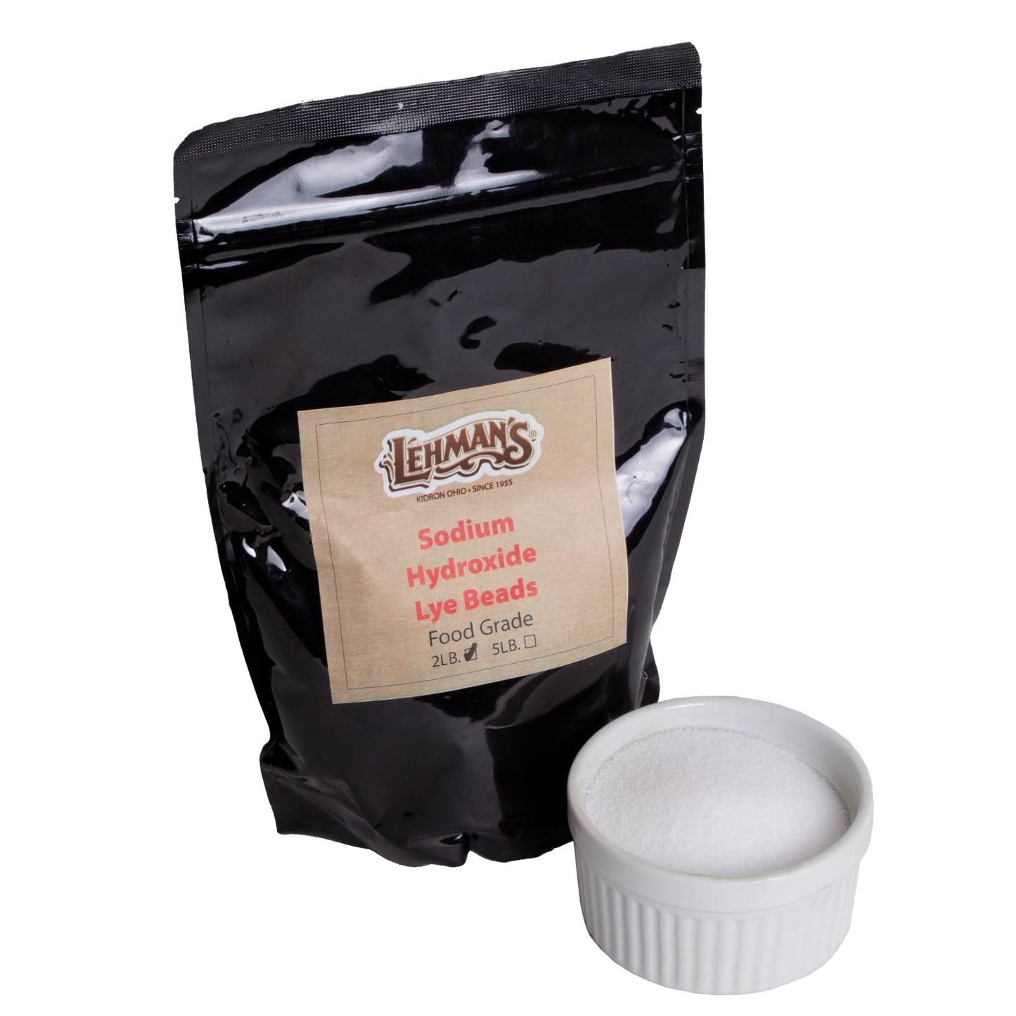 Resealable black pouch of food-grade sodium hydroxide lye beads with a white ceramic ramekin filled with pure white lye, featured in Health & Wellness and Soapmaking Supplies collections.