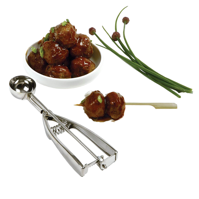 Handcrafted metal scoop with spring release creating uniform meatballs, displayed with a bowl of glazed meatballs and fresh chives, perfect for Kitchen & Food, Cookware, Baking Supplies, Kitchen Gadgets, Cooking and Baking Helpers, Best Sellers, and Promo Eligible collections.