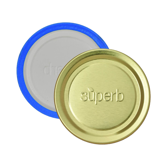 Two regular-mouth canning jar lids featuring a gold-tone metal top embossed with “superb” and a blue-sealed inner lining, designed for reliable food preservation in USA made kitchen collections.