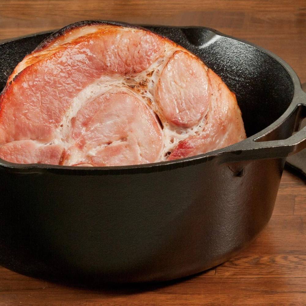 Handcrafted cast iron Dutch oven with a large cooked ham inside, made in USA, designed for excellent heat retention and slow-cooked savory meals, ideal for Kitchen & Food, Cast Iron, Cookware, USA Made, and Best Sellers collections.