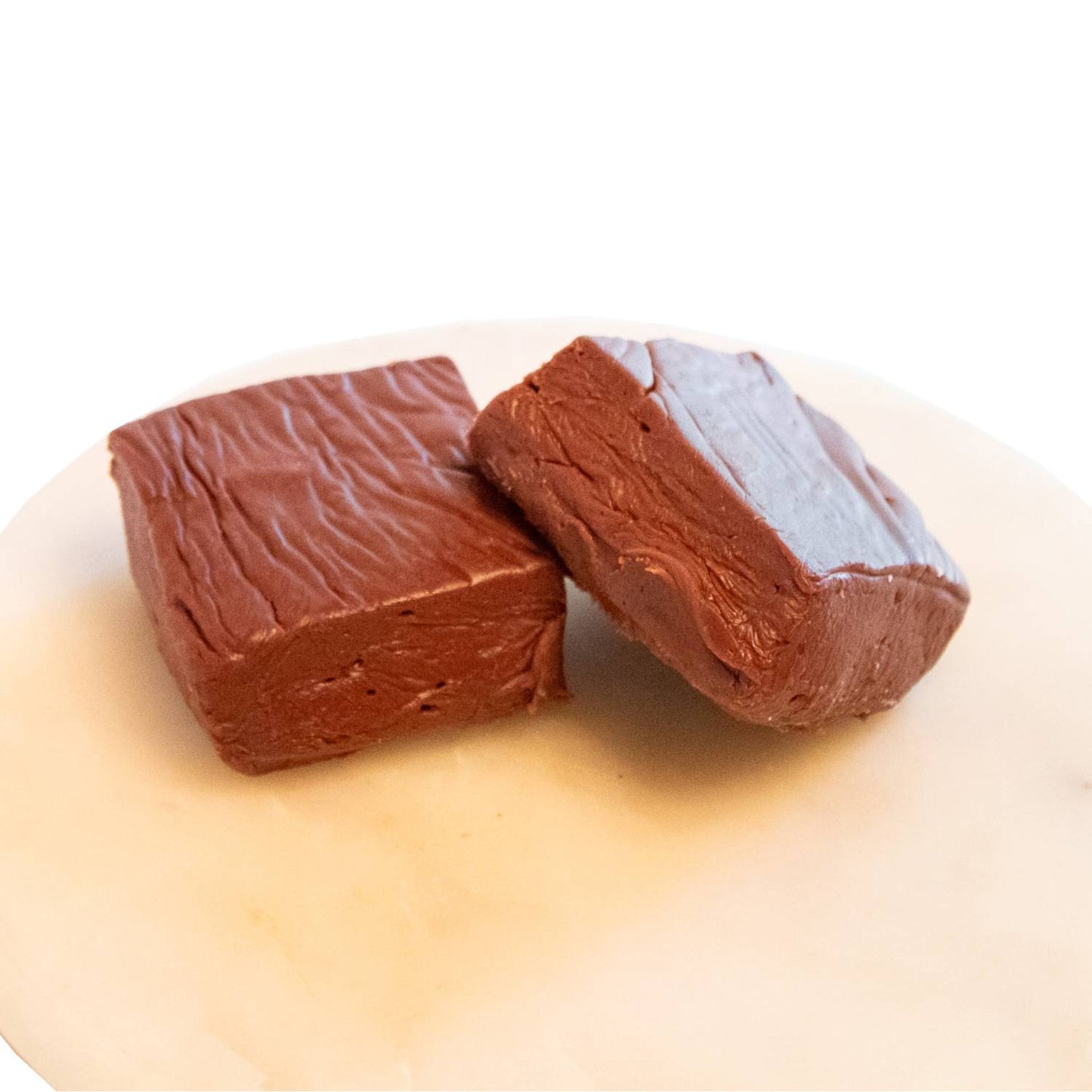 Two handcrafted rich chocolate fudge pieces with a creamy, smooth texture on a white marble surface, featured in Kitchen & Food, Snacks and Sweets, USA Made, Best Sellers, and Promo Eligible collections.