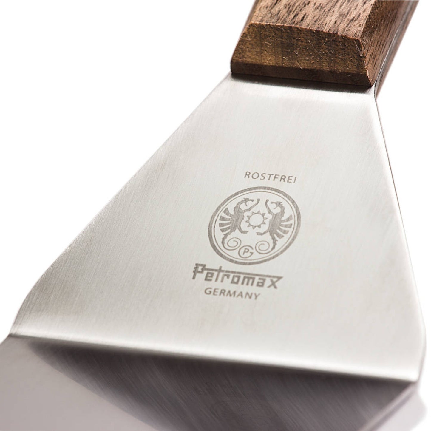 Close-up view of a stainless steel flexible spatula blade with an engraved Petromax logo and a smooth wooden handle, designed for Kitchen & Food, Grilling, and Cooking Helpers collections.