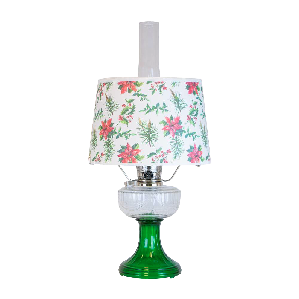 Handcrafted oil lamp with emerald green glass base and clear overlaid design, topped with festive parchment shade decorated with holly and poinsettia, featured in Lamps & Lighting and Table Lamps collections.