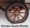 Close-up of a handcrafted wooden spoke wheel with solid rubber tire, part of specialty equipment designed for kitchen and food applications in a traditional ice cream trailer.