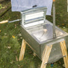 Handcrafted Amish-style metal laundry hand washer with wooden legs and built-in wringer, designed for efficient clothes washing in Outdoor Laundry Supplies and USA Made collections.