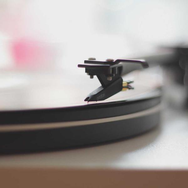 Close-up of a vintage turntable needle gently resting on a spinning vinyl record, evoking a nostalgic auditory experience for Best Sellers and P3 Testing collections.