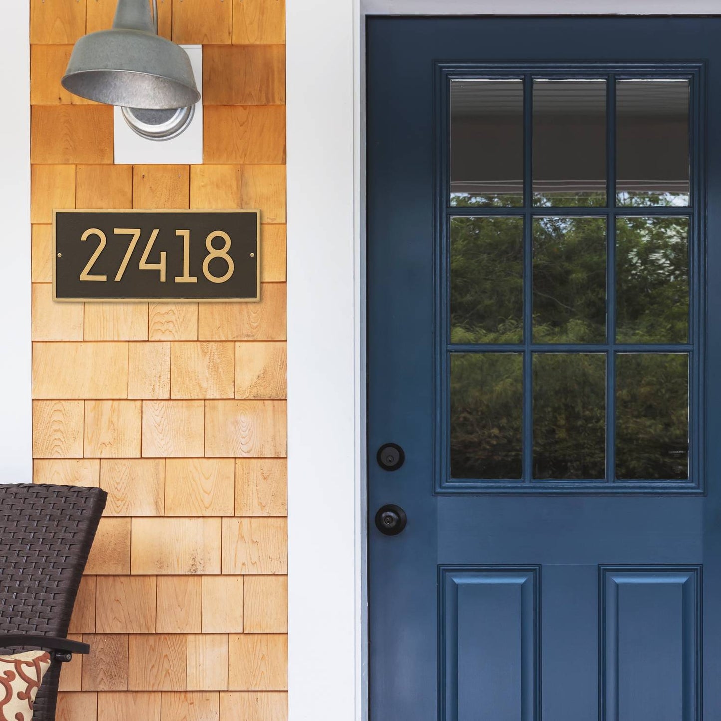 Modern custom wall plaque in aged bronze finish displaying house number on natural wood shingle siding, enhancing curb appeal in Home & Decor and USA Made collections.