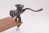 Heavy-duty metal clamp-down meat grinder with a curved hand crank attached to a wooden surface, ideal for Kitchen & Food, Specialty Equipment, Butchering Supplies, USA Made, Best Sellers, and Promo Eligible collections.