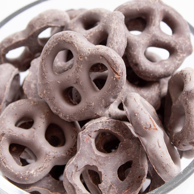 Handcrafted chocolate covered mini pretzels made in USA, combining salty and sweet flavors in a 14 oz bag, ideal for Kitchen & Food, Snacks and Sweets, Candy, USA Made, Best Sellers, and Promo Eligible collections.