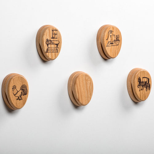 Set of five handcrafted oak towel holders with clear protective finish, featuring rustic engraved designs of a rooster, sewing machine, pump, buggy, and a plain one, made in USA, Amish made, ideal for Home & Decor and Household Helpers collections.