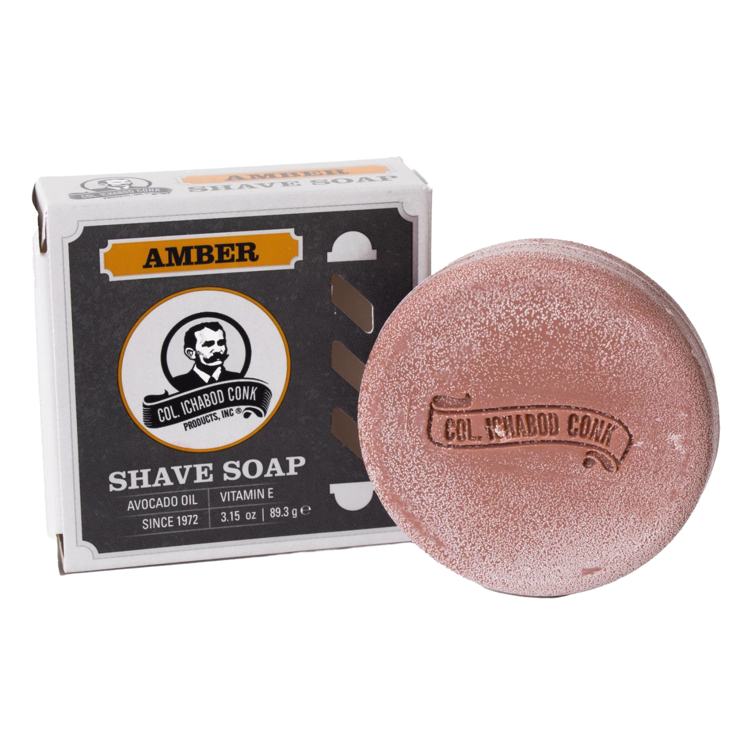Round amber-colored shaving soap bar with embossed branding beside its box, containing avocado oil and vitamin E, crafted in USA, featured in Health & Wellness and Grooming collections.
