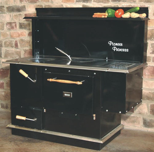 Black Pioneer Princess wood cookstove with porcelain finish, large cooktop and oven, wooden handles, and a backdrop of fresh vegetables, perfect for Stoves, Cookstoves, and Best Sellers.