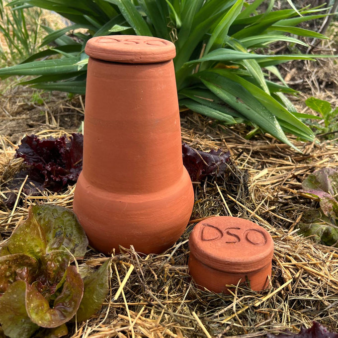 Unglazed terra cotta irrigation pot and lid with carved top, handcrafted for efficient water conservation in small garden beds and planters, featured in Farm, Garden & Tool collections.