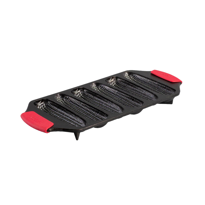 Seasoned cast iron cornstick pan with six elongated molds, dual red silicone handles, and angled feet for oven stability, handcrafted in USA, ideal for Kitchen & Food and Cast Iron cookware collections.