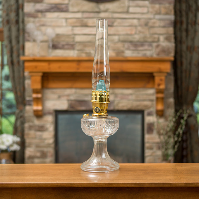 Handcrafted clear glass oil lamp with polished brass burner and tall chimney featuring a Lincoln Drape pattern, part of Lamps & Lighting, Oil Lamps, Table Lamps, Best Sellers, and Promo Eligible collections.