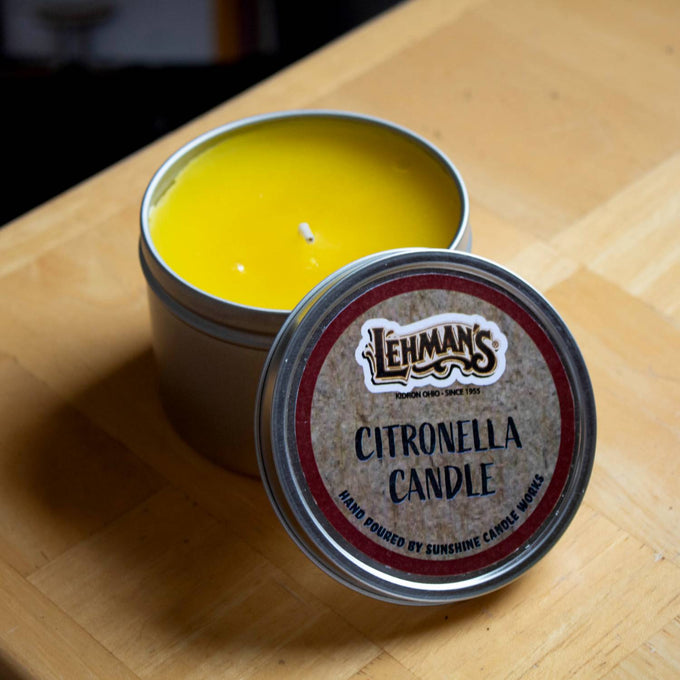 Hand-poured bright yellow citronella candle in a compact metal tin with a branded lid, handcrafted for outdoor use in camping, pest control, and farm, garden & tool collections.