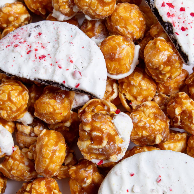 Close-up of handcrafted caramel popcorn mixed with peppermint bark pieces featuring crushed candies, perfect for Kitchen & Food, Snacks and Sweets, Popcorn, Best Sellers, and Promo Eligible collections.