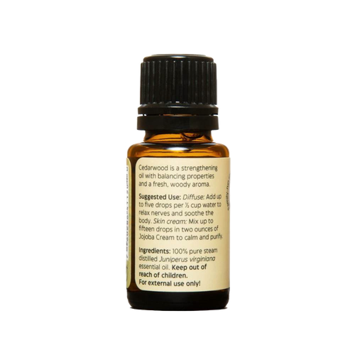 Amber glass bottle of pure essential oil with black cap and label detailing suggested uses and ingredients, ideal for health remedies, aromatherapy, and soapmaking.