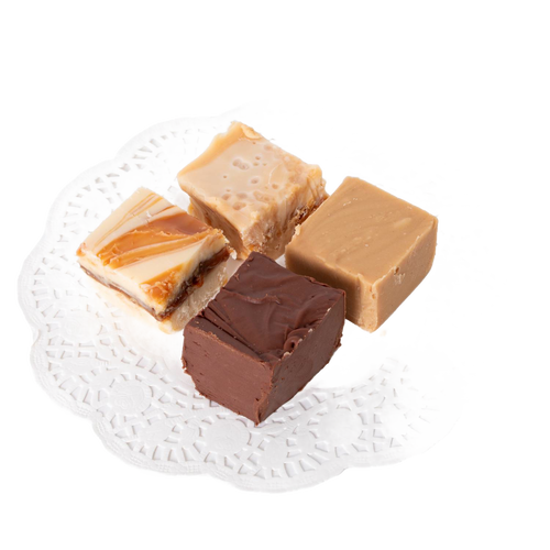Four handcrafted creamy fudge squares in varied flavors including chocolate, praline, and caramel swirled, arranged on a white lace paper doily, ideal for Kitchen & Food and Snacks and Sweets collections.