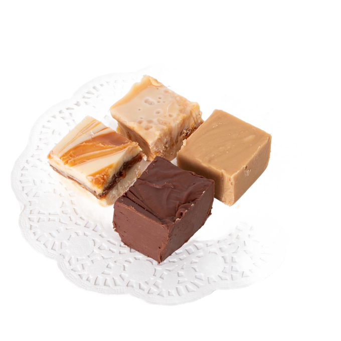 Four handcrafted creamy fudge squares in varied flavors including chocolate, praline, and caramel swirled, arranged on a white lace paper doily, ideal for Kitchen & Food and Snacks and Sweets collections.