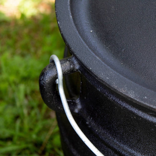 Close-up of a durable cast iron campfire kettle handle with attached wire bail, showcasing handcrafted quality for outdoor cooking in Farm, Garden & Tool, Camping, Best Sellers, and Promo Eligible collections.