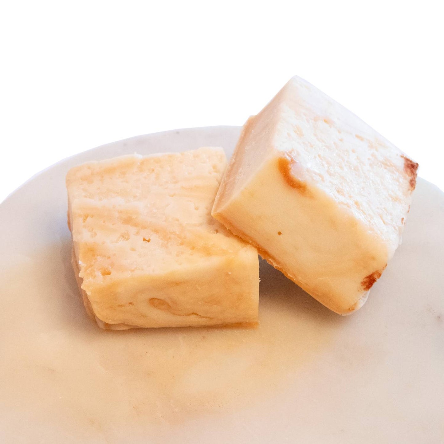 Two handcrafted creamy white fudge pieces with a rich, smooth texture on a light marble surface, featured in Kitchen & Food, Food, Snacks and Sweets, USA Made, Best Sellers, and Promo Eligible collections.