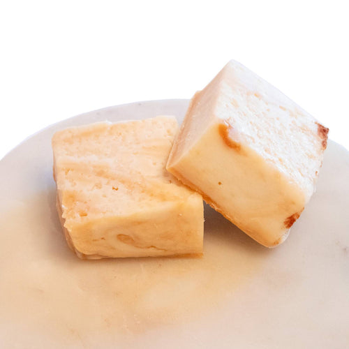 Two handcrafted creamy white fudge pieces with a rich, smooth texture on a light marble surface, featured in Kitchen & Food, Food, Snacks and Sweets, USA Made, Best Sellers, and Promo Eligible collections.