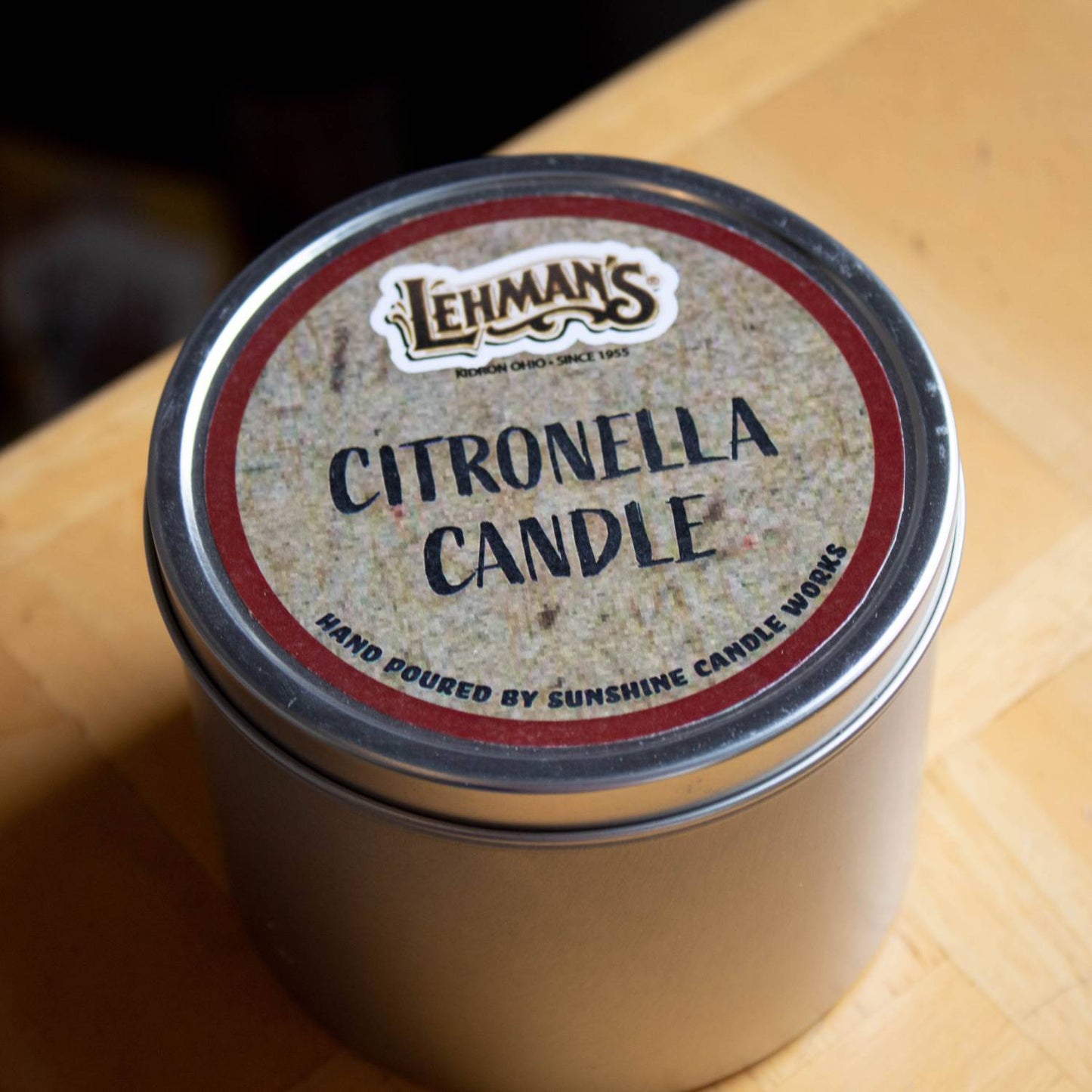 Handcrafted citronella candle in a round metal tin with branded label, ideal for outdoor use in camping, garden, pest control, and lamps & lighting collections.