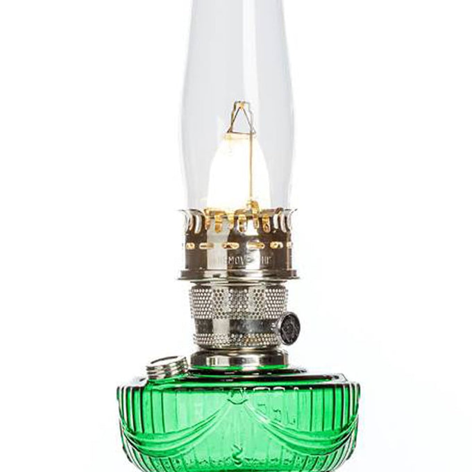 Handcrafted oil lamp with an emerald green glass font and brass trim, designed for Lamps & Lighting, Oil Lamps, Table Lamps, Best Sellers, and Promo Eligible collections.