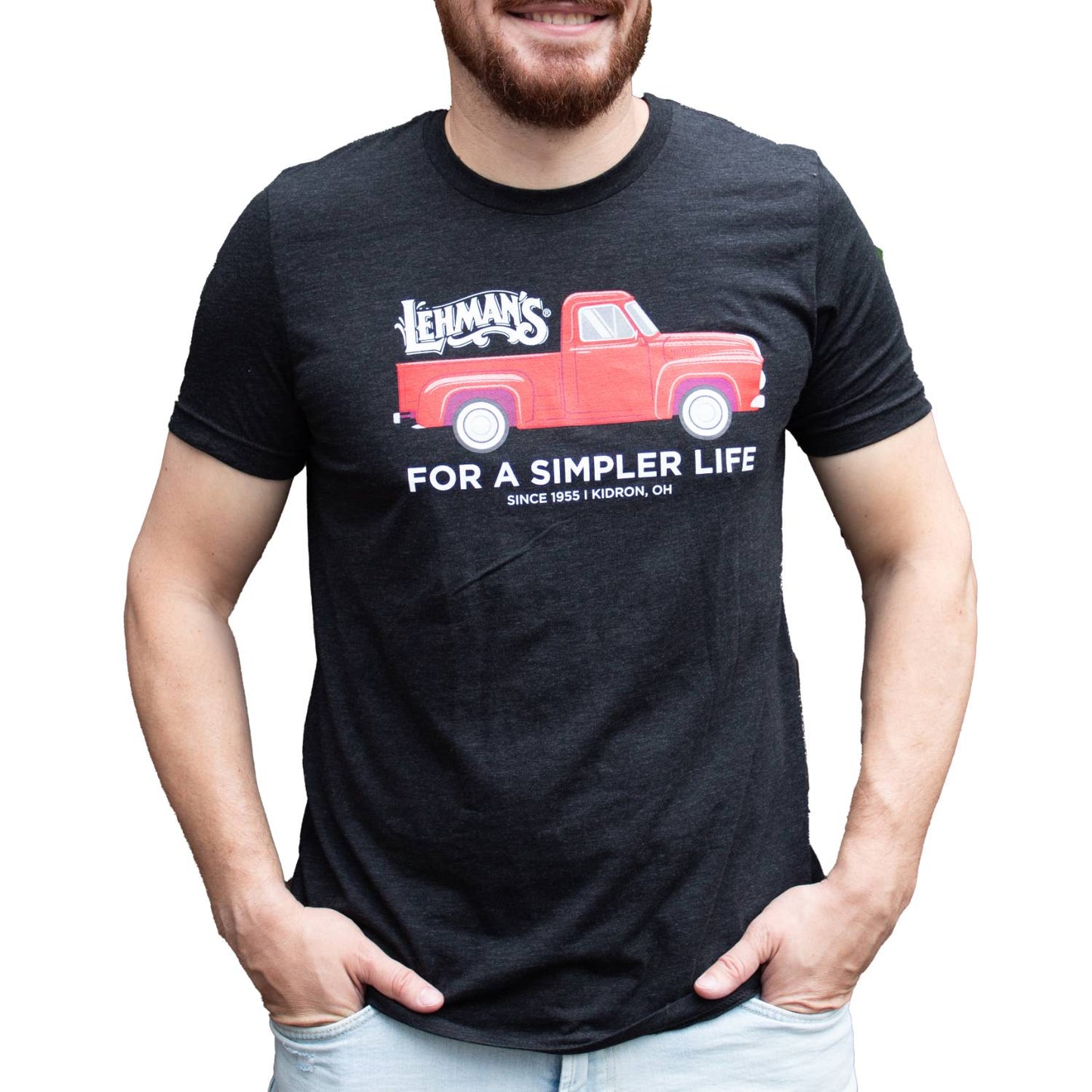 Adult wearing a handcrafted charcoal soft cotton t-shirt with a bright red vintage truck graphic, Lehman's logo, and "For a Simpler Life" text, part of Health & Wellness, Clothing, Best Sellers, and Promo Eligible collections.