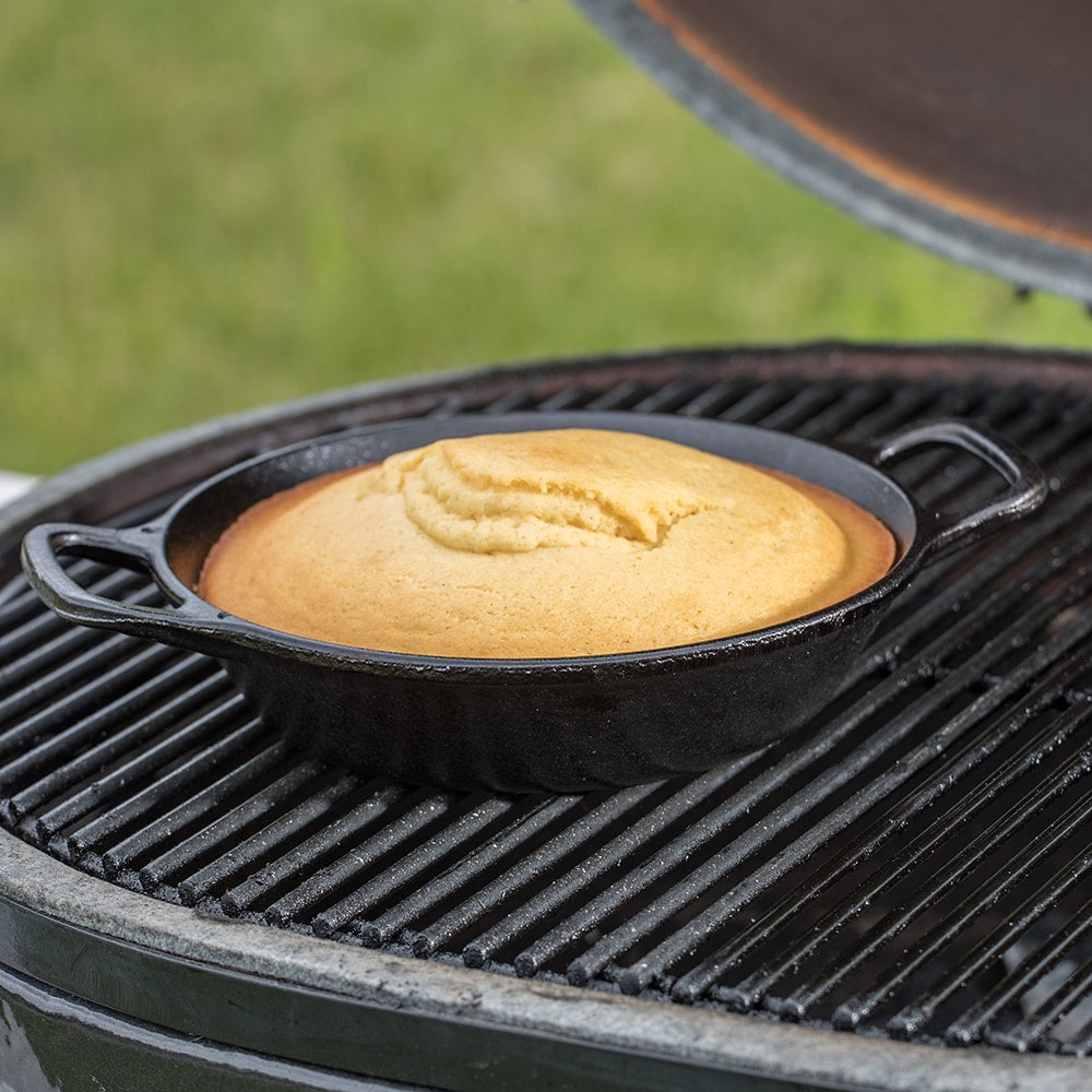 Handcrafted round cast iron pan with short side handles baking golden cornbread on a grill, featured in Kitchen & Food, Cookware, Cast Iron, Best Sellers, Promo Eligible collections.