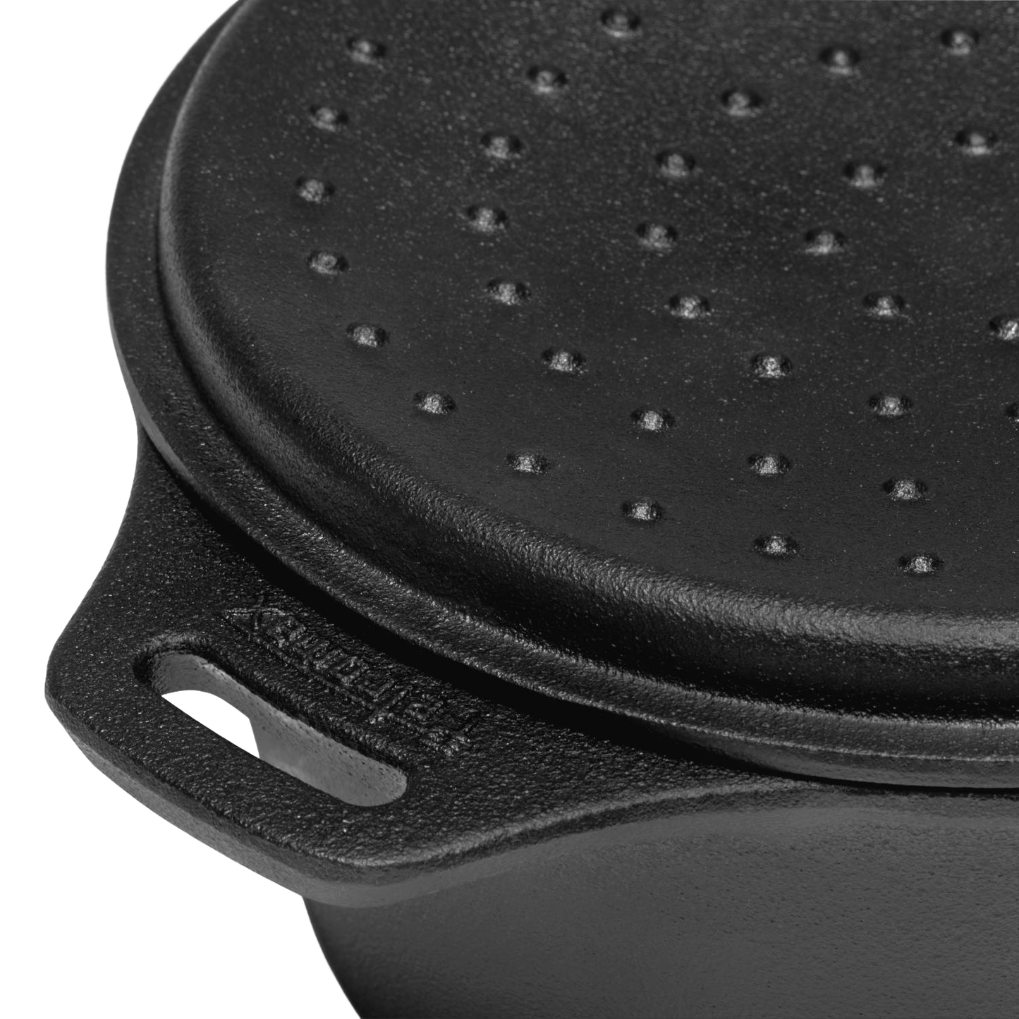 Close-up of a durable cast iron saucepan lid with raised self-basting bumps and sturdy handle, designed for precise pouring and outdoor cooking in farm, garden, camping, and cookware collections.