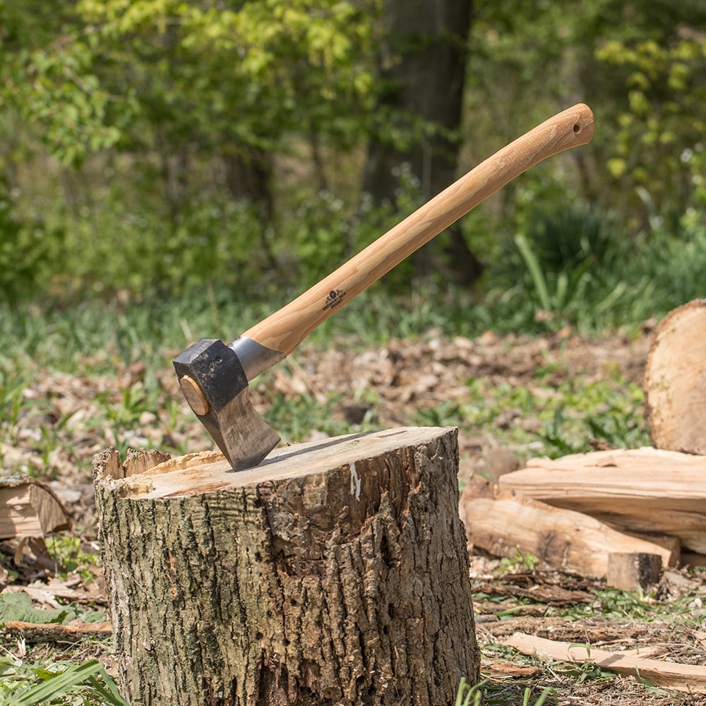 Hand-forged splitting axe with a sharp steel head and smooth wooden handle embedded in a tree stump, ideal for wood cutting and hauling, featured in Farm, Garden & Tool and Axes collections.