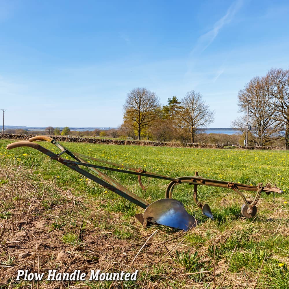Rustic farming plow with Amish-made hardwood handles mounted on a metal cultivator frame, set in a bright rural field, featured in Farm, Garden & Tool and Digging and Cultivating collections.
