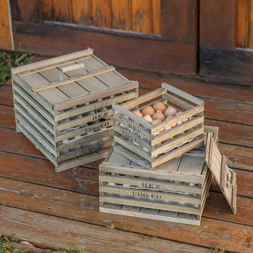 Set of handcrafted wooden egg crates with slatted sides and hinged lids, holding fresh eggs; ideal for farm, garden, animal care, and chicken accessory use in promotional collections.