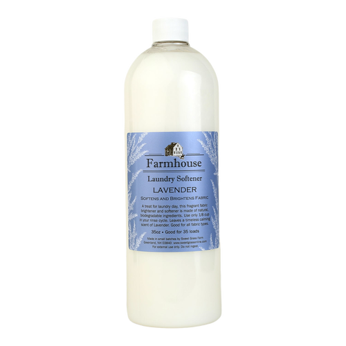 Tall translucent bottle of lavender-scented fabric softener with a blue label featuring a farmhouse illustration, part of USA made laundry supplies and best sellers collections.