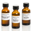 Three amber glass bottles with black caps containing handcrafted candle scents labeled Christmas Spruce, Bayberry, and Lavender, ideal for lamps, candlemaking, and supplies.