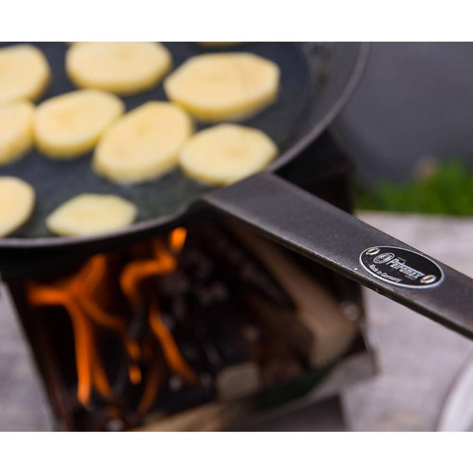 Durable wrought iron pan with a long handle cooking sliced potatoes over an open flame on a portable stove, ideal for Farm, Garden & Tool, Kitchen & Food, Camping, Cookware, Pots and Pans, Best Sellers, and Promo Eligible collections.