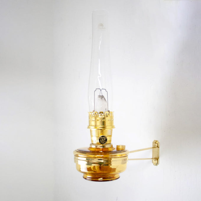 Wall-mounted amber glass oil lamp with brass fixture and tall chimney, handcrafted in USA, ideal for Farm, Garden & Tool, Lamps & Lighting, and Emergency Supplies collections.