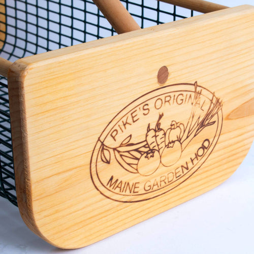 Close-up of a handcrafted wooden end panel with engraved logo on a wire mesh garden hod, made in USA, part of Farm, Garden & Tool, Garden Accessories, and Best Sellers collections.
