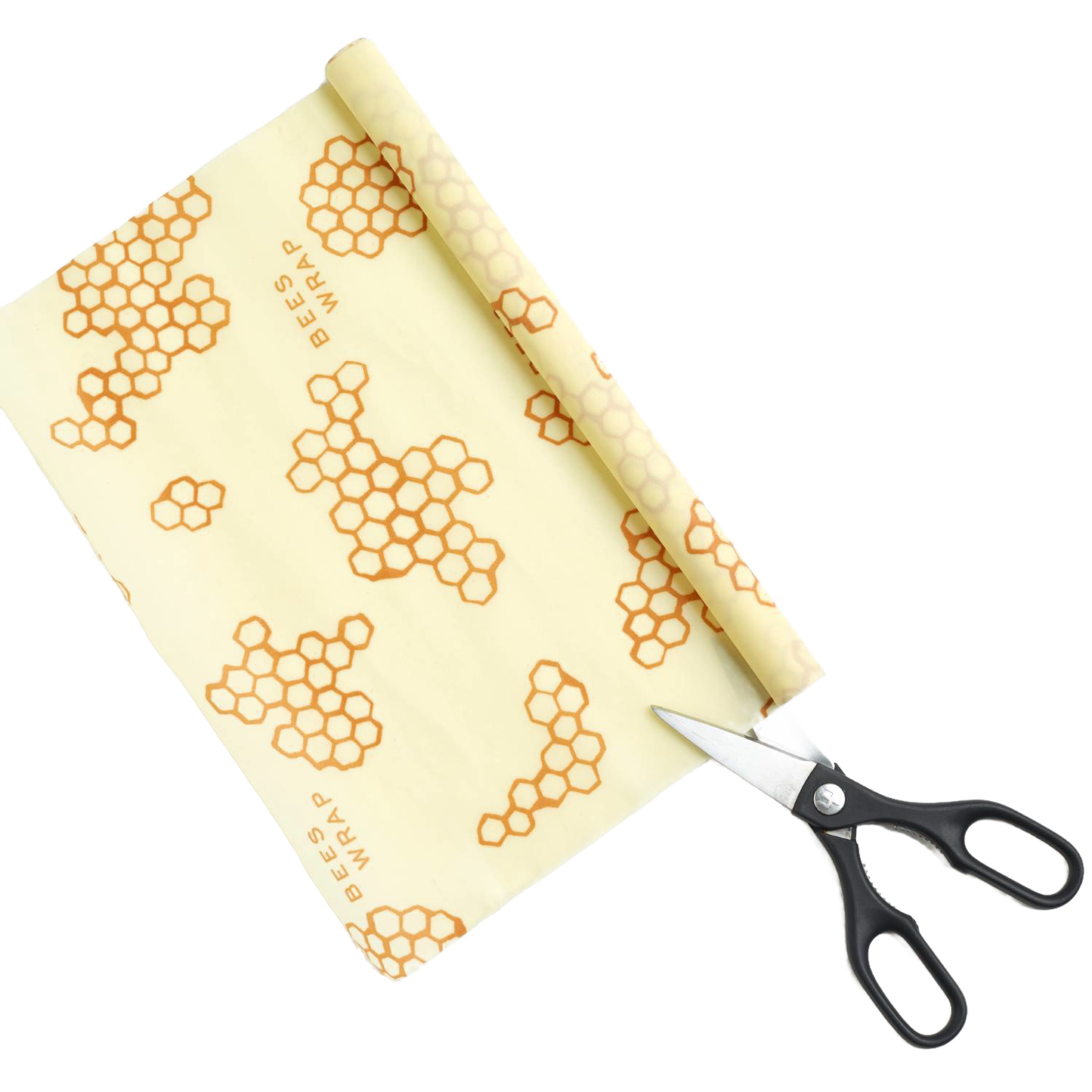 Roll of cream-colored beeswax food wrap printed with honeycomb patterns, partially unrolled next to black-handled scissors, handmade and USA made, ideal for Kitchen & Food and Storage collections.