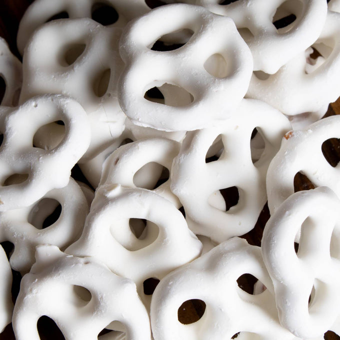 Close-up of handcrafted mini pretzels generously coated in creamy white chocolate, made in USA, a tasty snack from Kitchen & Food, Snacks and Sweets, Candy, Best Sellers, Promo Eligible collections.