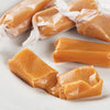 Soft, buttery hand-wrapped caramel candies with a smooth texture, showcasing a classic old-fashioned style, perfect for Kitchen & Food, Snacks and Sweets, and USA Made collections.
