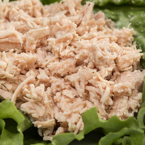 Close-up of shredded handcrafted canned turkey served on fresh green lettuce, highlighting a convenient, long-lasting protein option for Farm, Garden & Tool, Kitchen & Food, Emergency Supplies, Food, Meats, Best Sellers, and Promo Eligible collections.