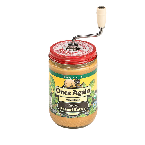 Classic peanut butter stirrer with molded plastic knob attached to a jar of creamy organic peanut butter, designed to prevent oily messes, ideal for Kitchen & Food and USA Made collections.