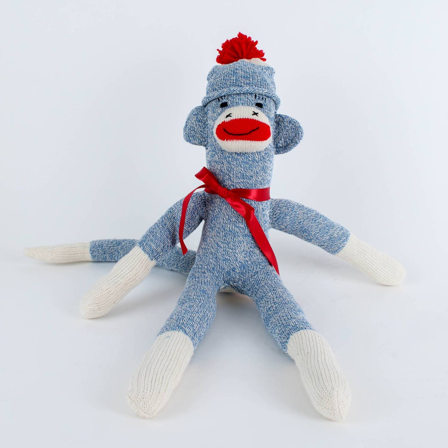 Handcrafted blue and white sock monkey with red pom-pom hat and matching ribbon, made in USA, featured in Toys, Books & Games, USA Made, Children's Toys, Indoor Play, and Best Sellers collections.
